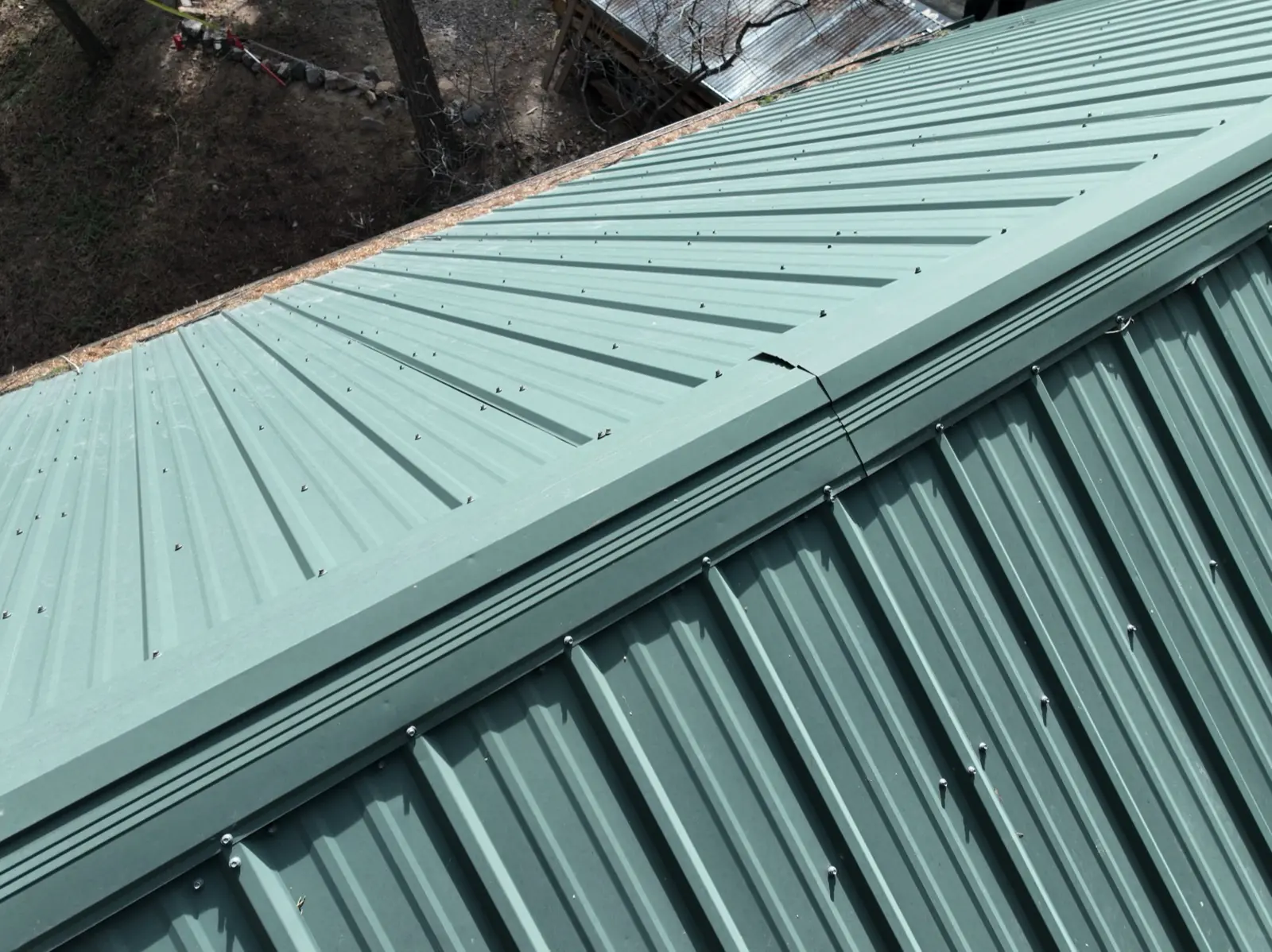 Metal roof showing hail damage in Colorado, inspected by Gates Enterprises