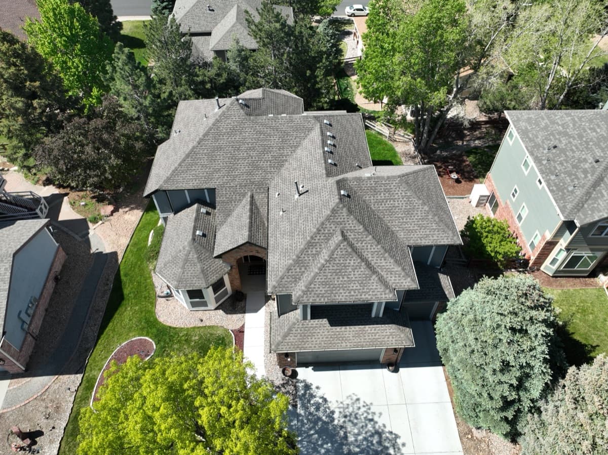 Old damaged roof in Parker Colorado before replacement by Gates Enterprises