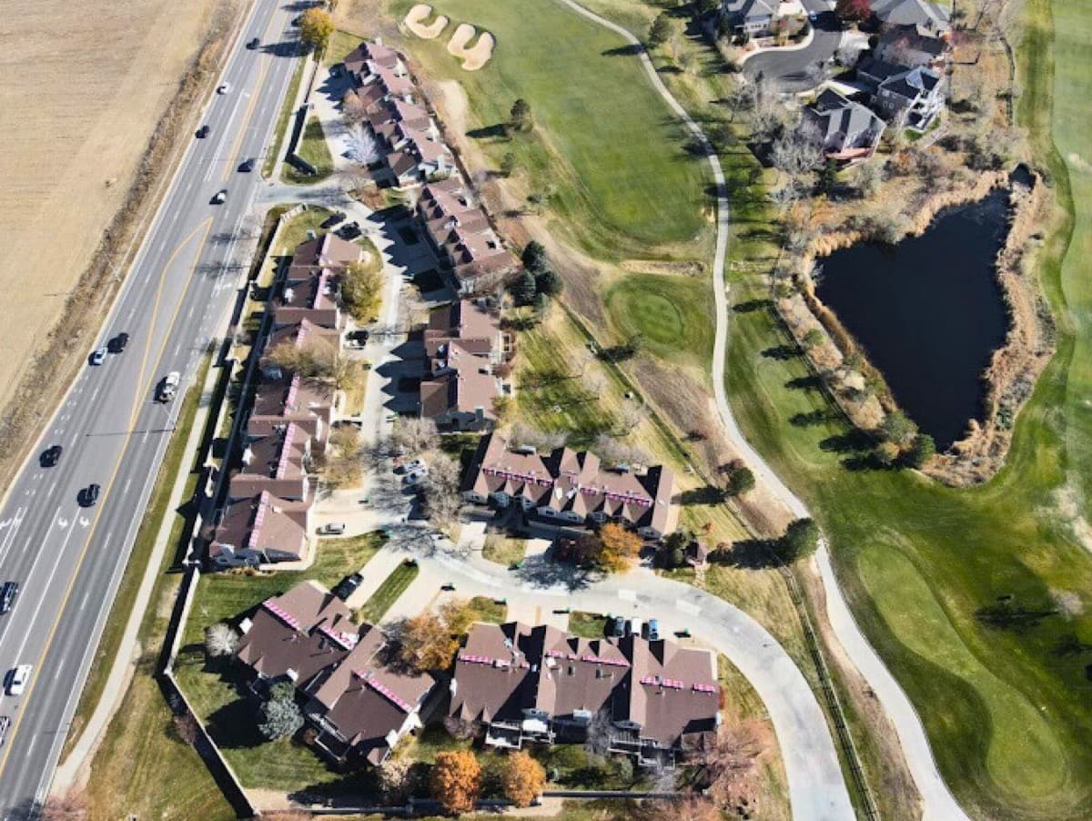 Aerial view of large apartment and townhome community roofing project