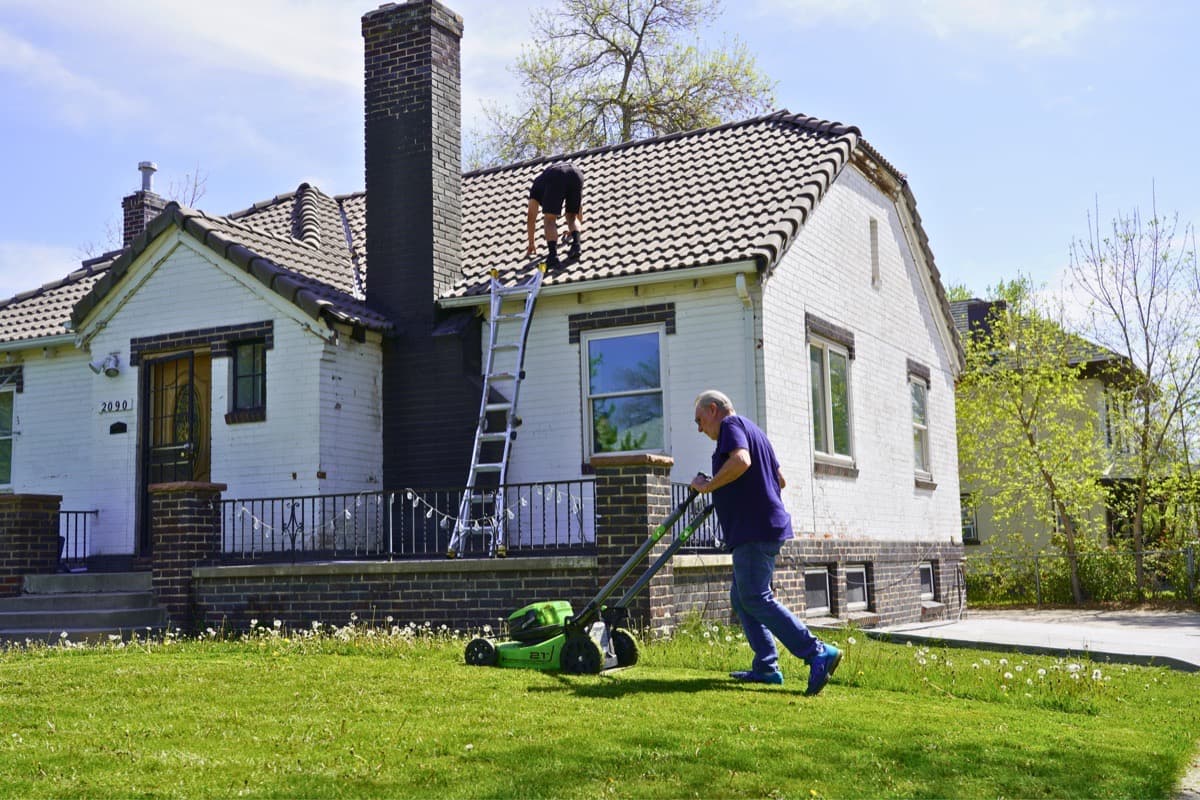 Roof inspection in progress with team member on tile roof