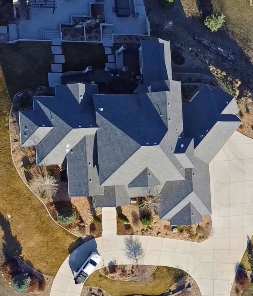 Aerial view of luxury estate with completed designer shingle roof
