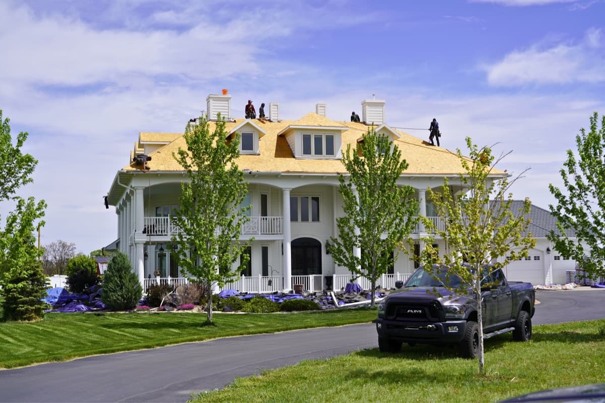 Large estate roof replacement in progress with full crew on site