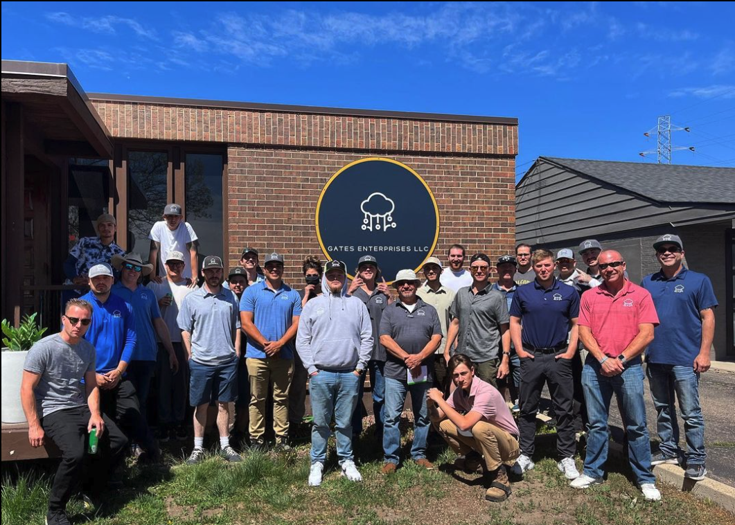 Gates employees in front of building